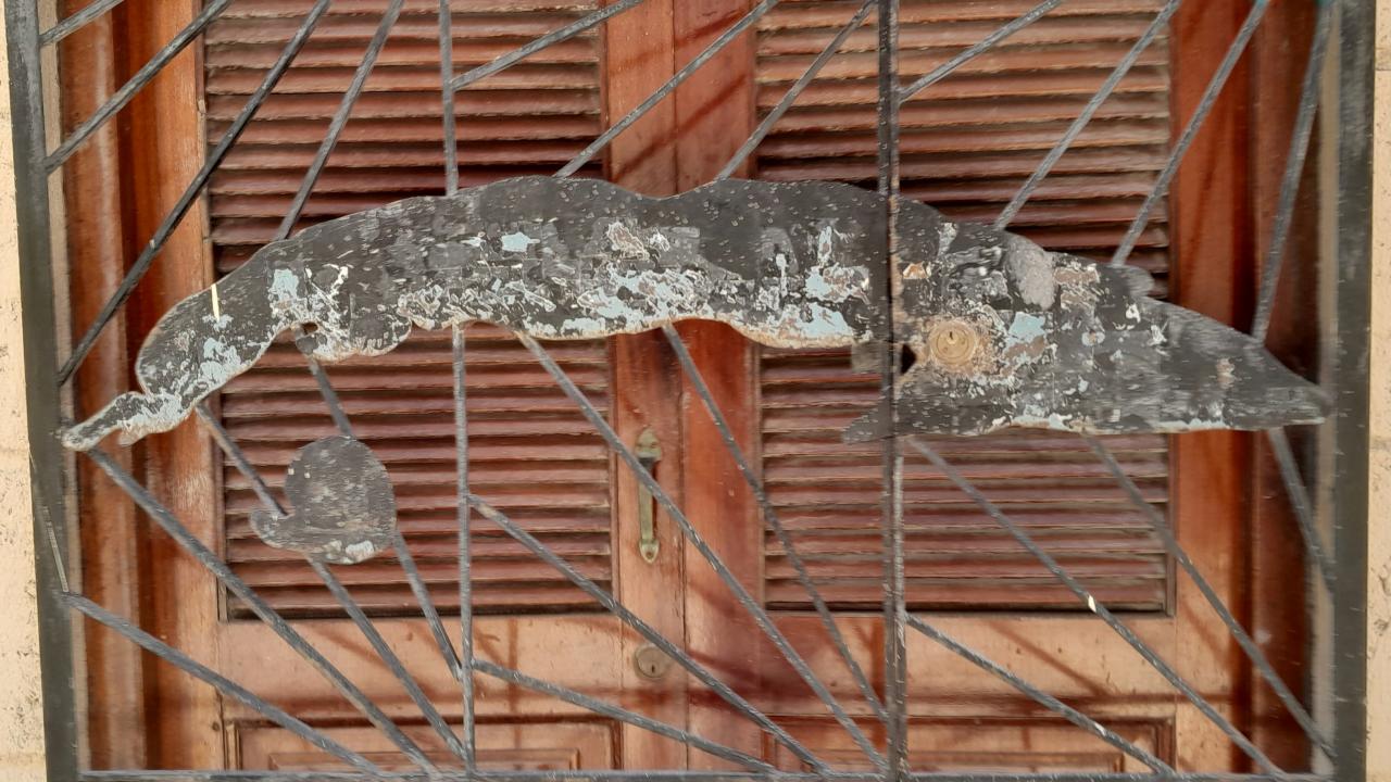 The Island of Cuba decorates a window grille.